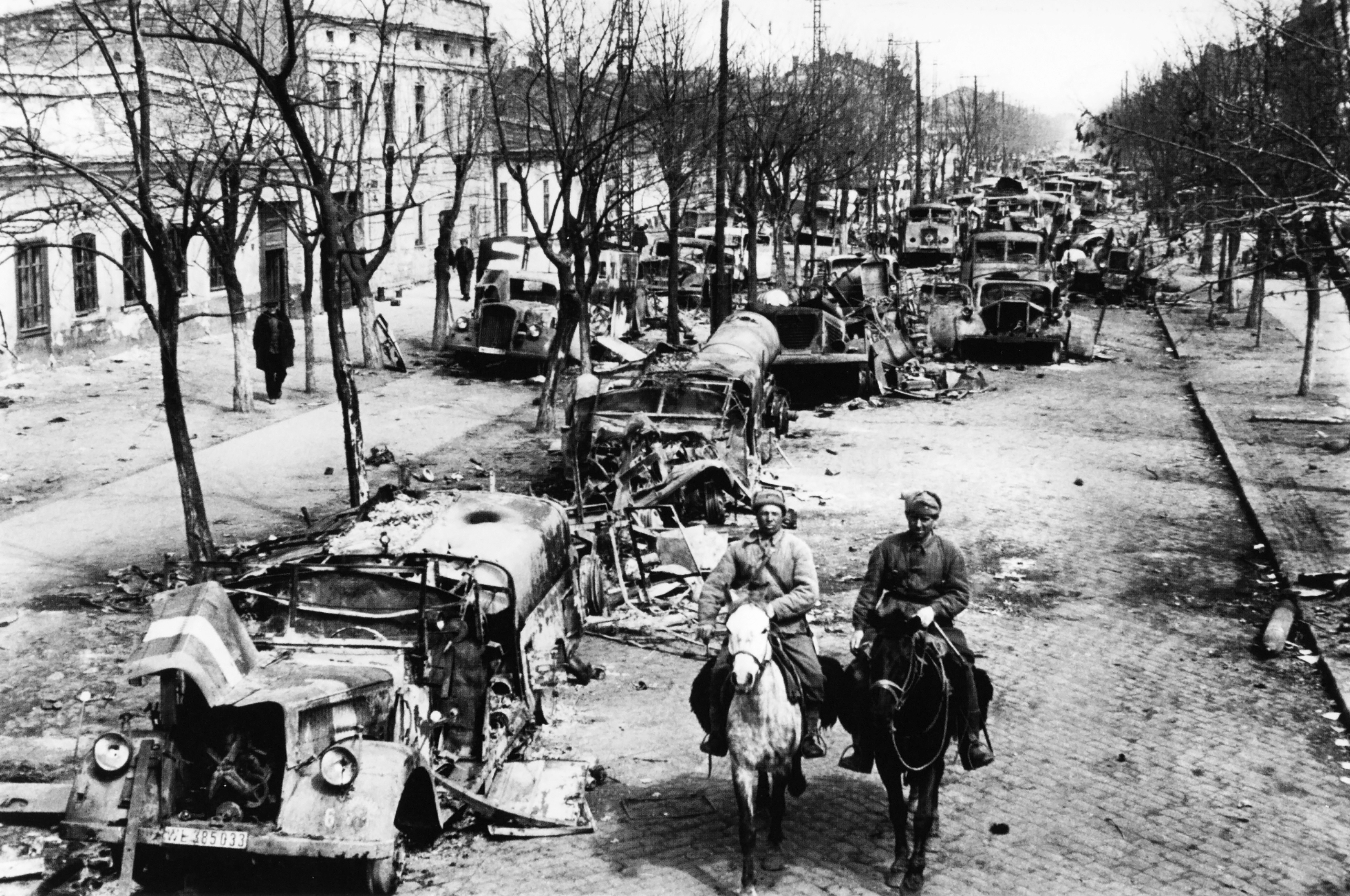 Two Red Army riders in a liberated Odessa street choked with destroyed