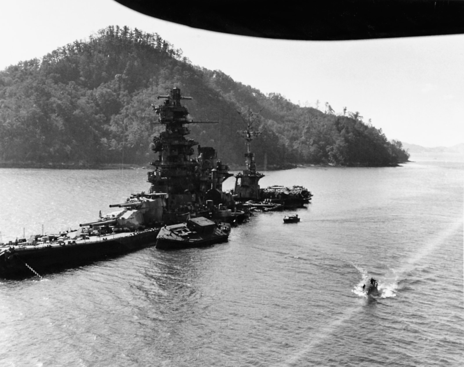 The Japanese battleship Hyuga lies in shallow water of the Kure naval