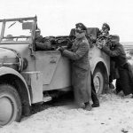 Erwin Rommel pushes his His staff car who was stuck in the sand.jpg