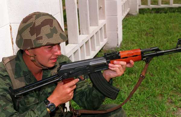 a bulgarian soldier armed with an aks 47 rifle stands by for the signal to 5ac2d0 1600