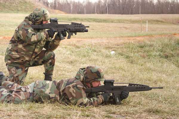 One tester is kneeling with a XM8 Carbine and XM320 attached, the other has the XM8 sharpshooter