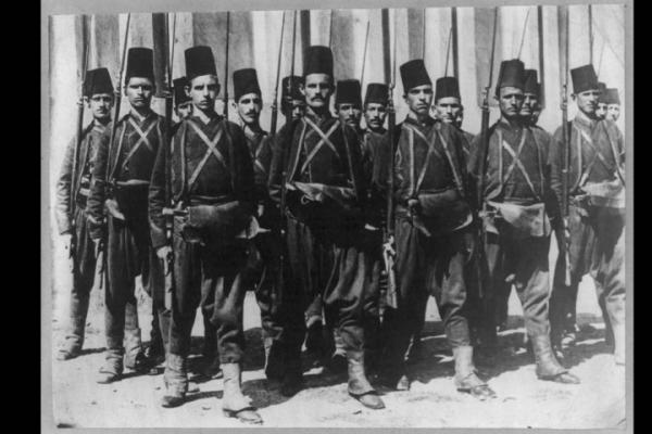 A troop of Turkish soldiers pose with their rifles, circa 1912 or 1913
