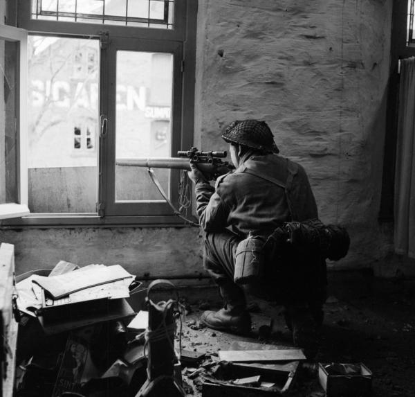 A sniper from  C  Company, 5th Battalion, The Black Watch in position in a ruined building in Gennep, Holland, 14 February 1945. B14626
